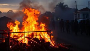 Generate an image of a burning barricade in Maputo, the capital of Mozambique, with protesters clashing with police and military in the background, symbolizing the current unrest.